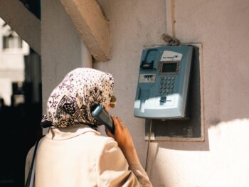 woman standing with vintage telephone