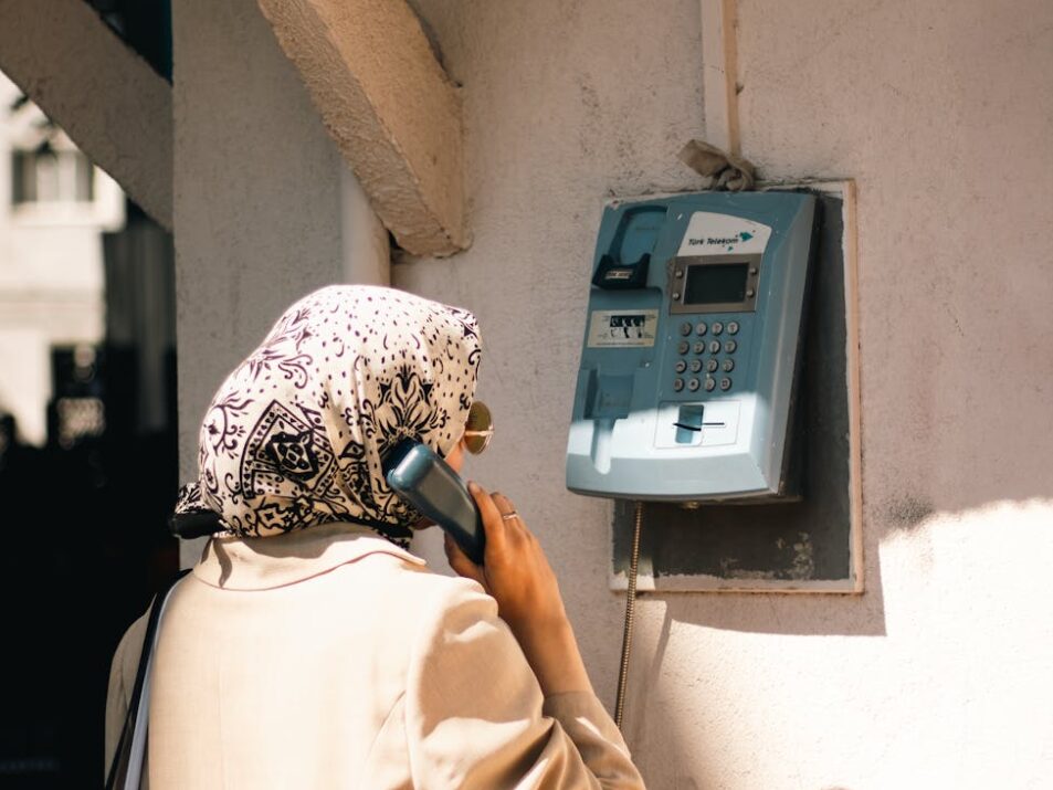 woman standing with vintage telephone