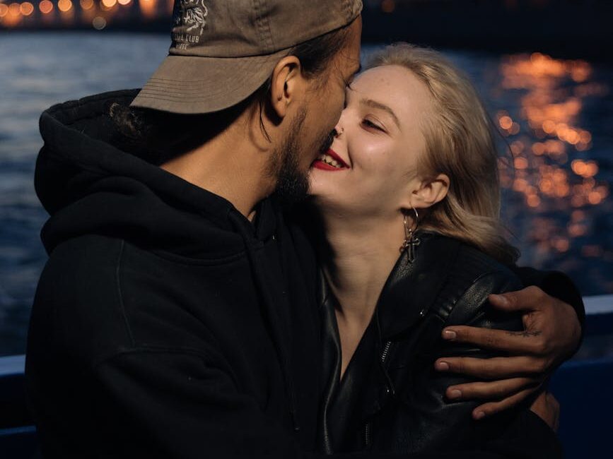 man and woman wearing black jacket and gray cap