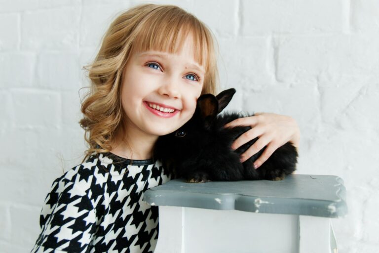 girl holding black rabbit