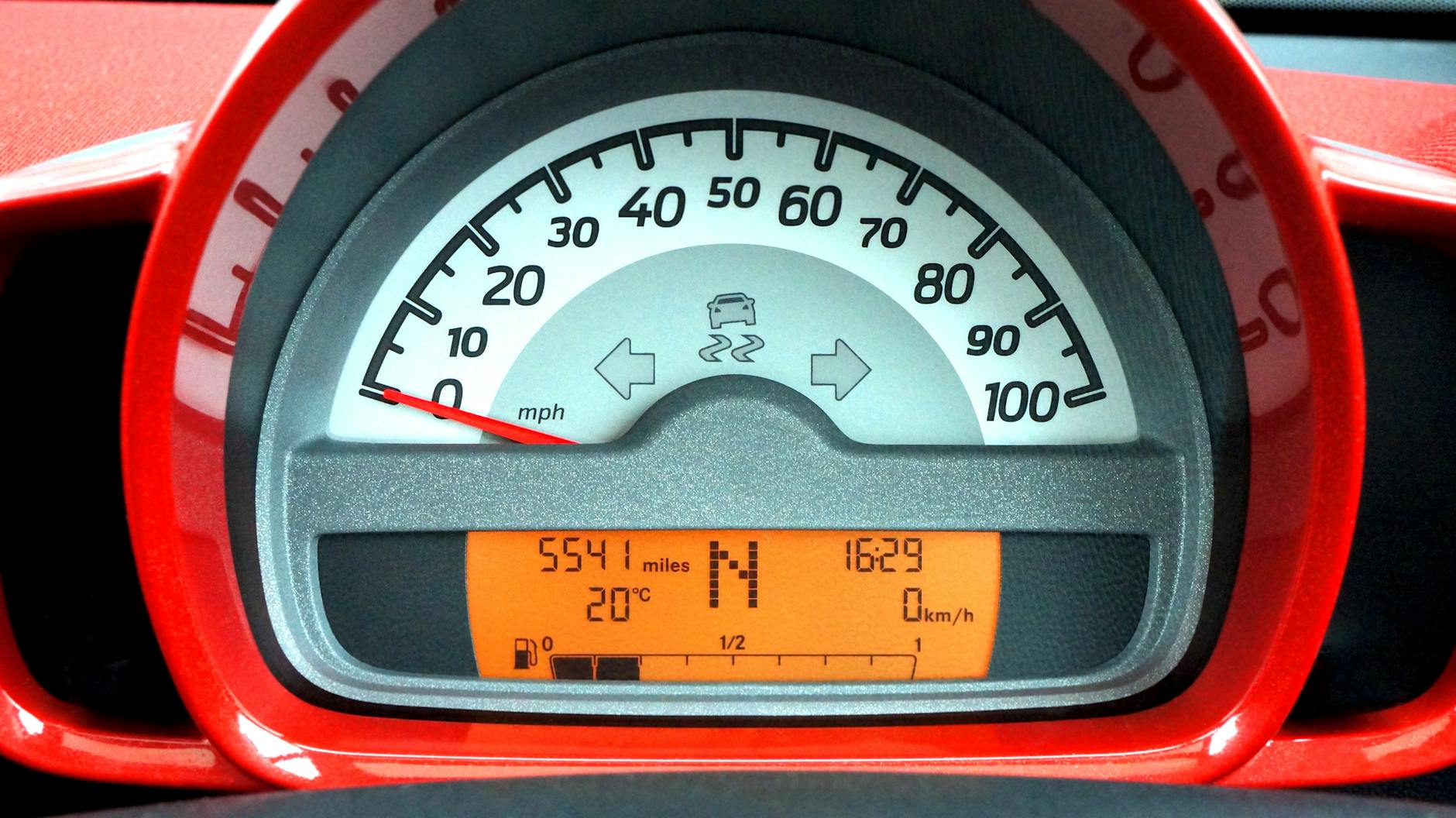 red and black car speedometer at neutral