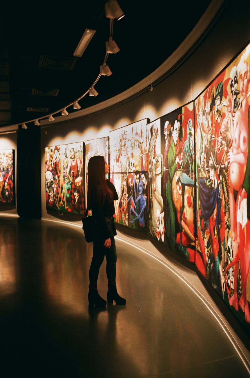 woman standing near paintings