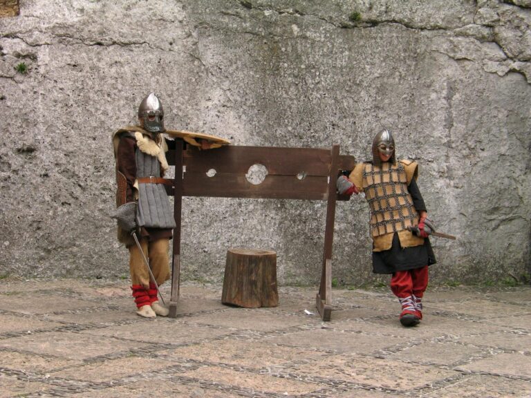 photo of people wearing medieval costumes posing with a guillotine