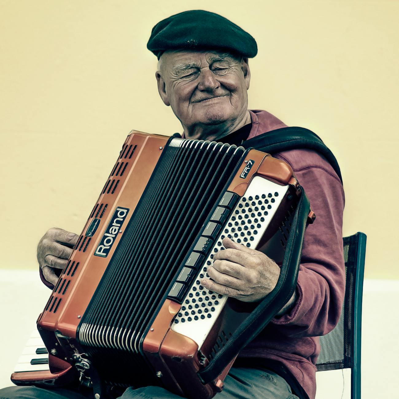 man sitting playing accordion