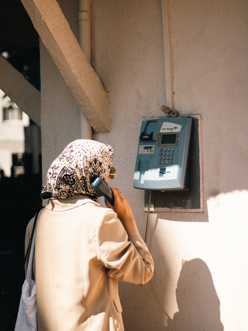 woman standing with vintage telephone