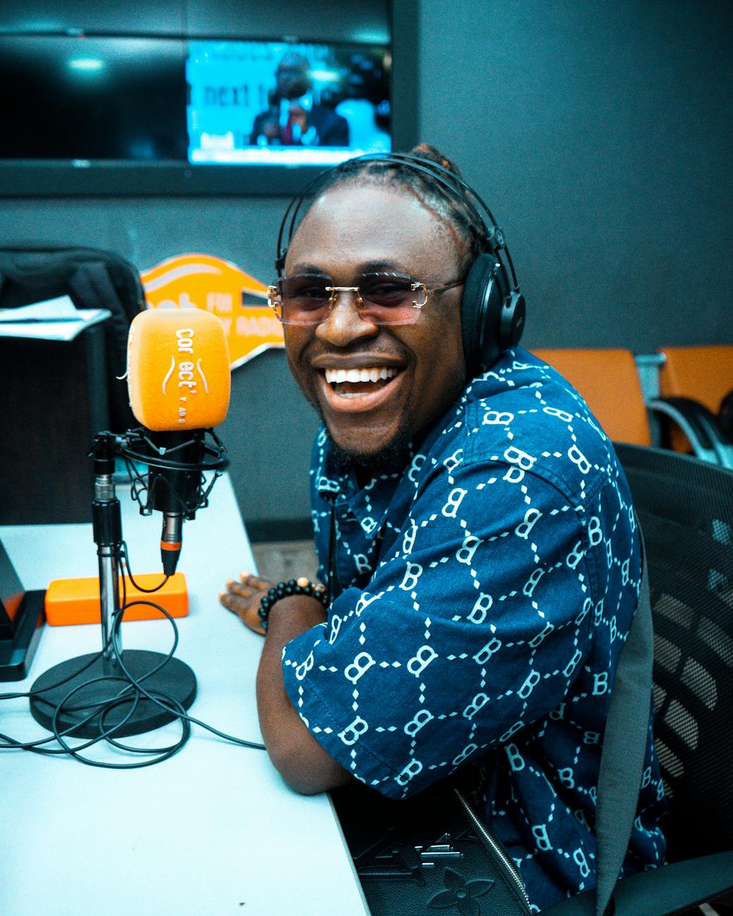 cheerful man in radio studio with microphone
