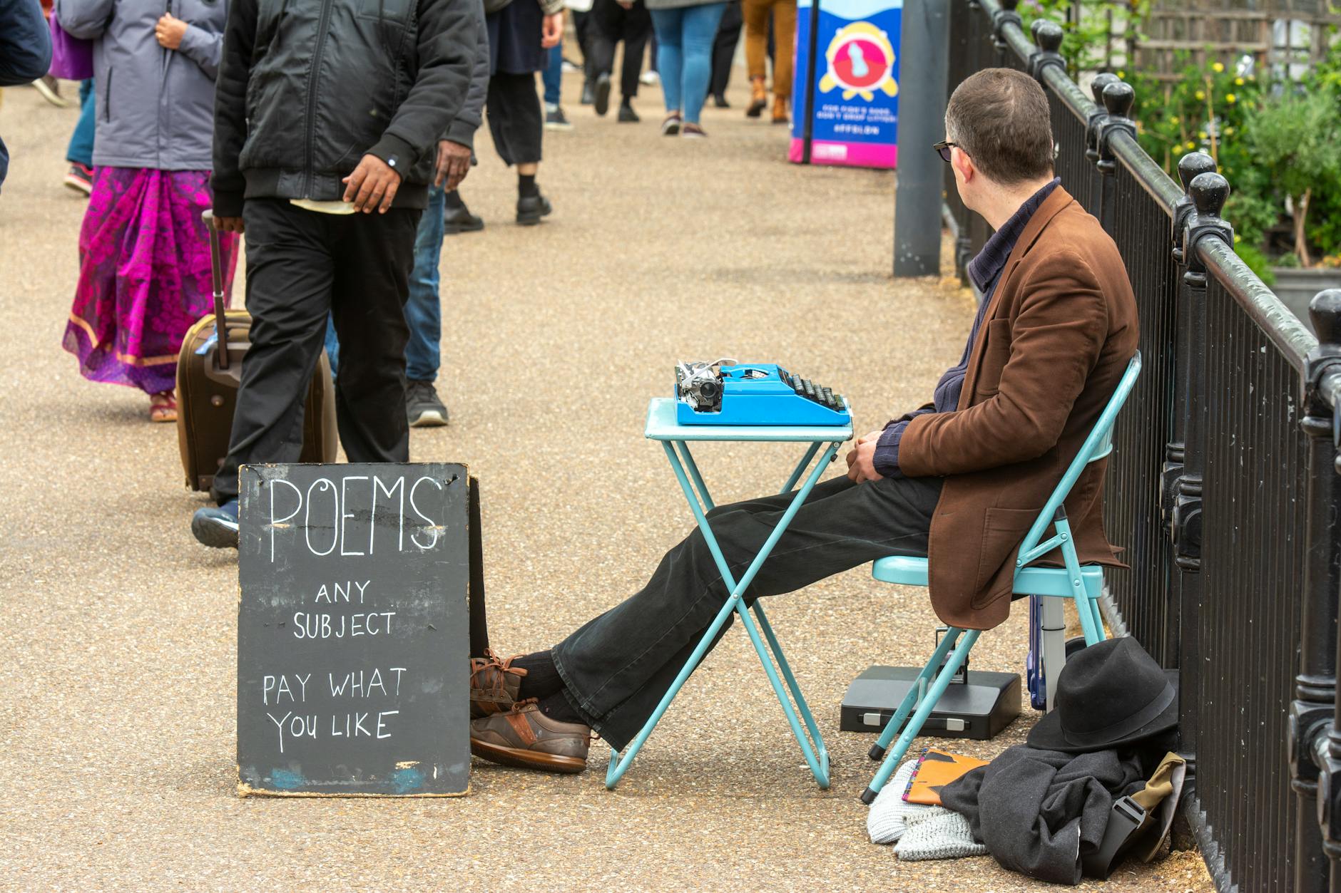 street poet with typewriter offering custom poems