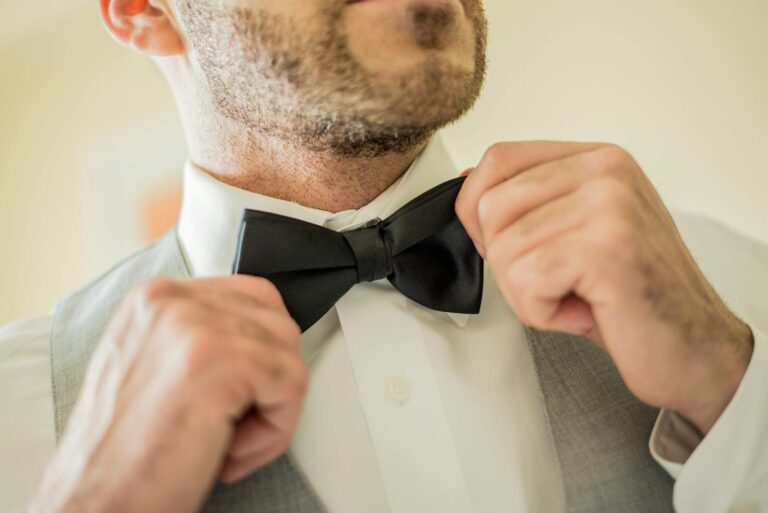 man holding his bowtie