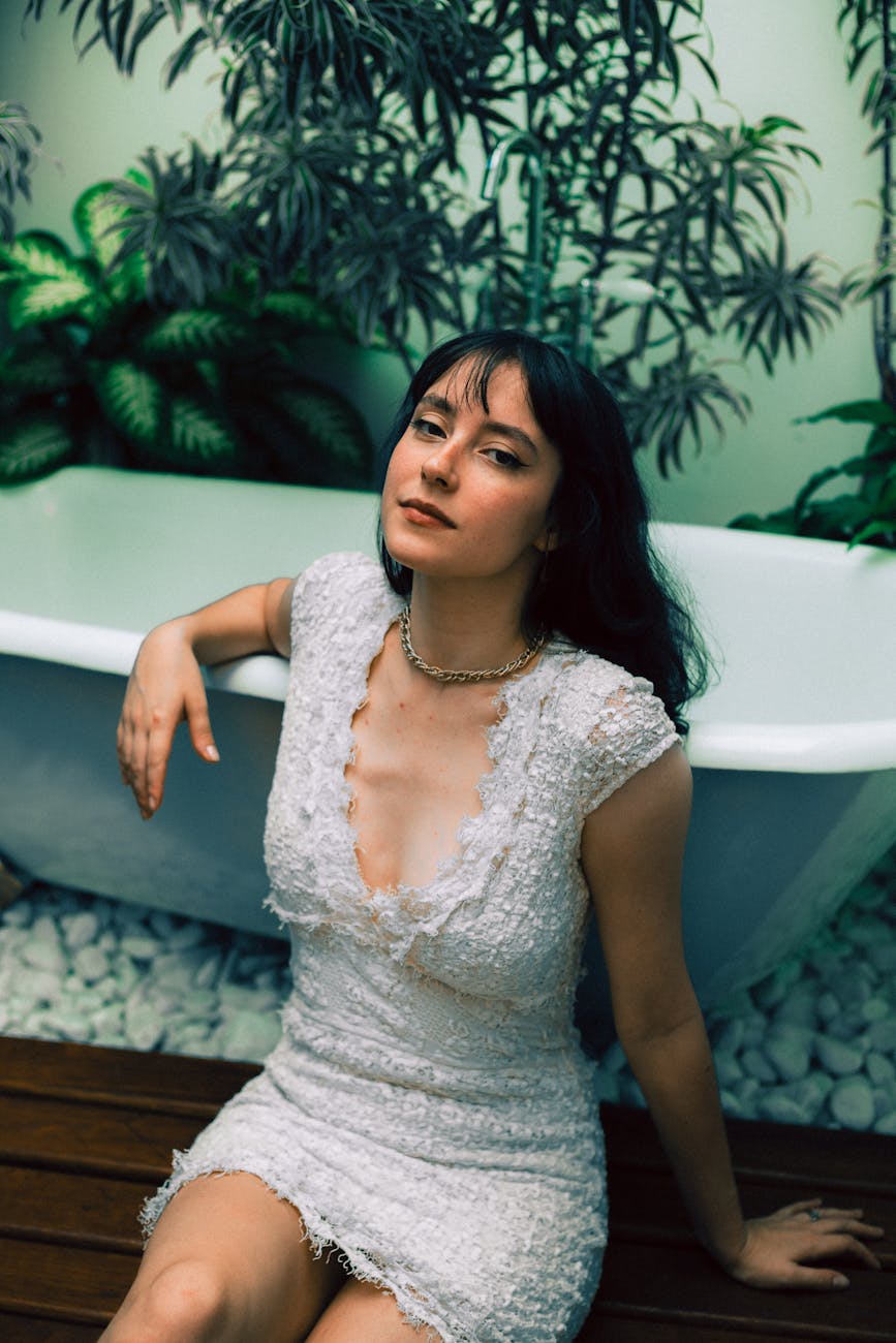 elegant woman in white dress by bathtub