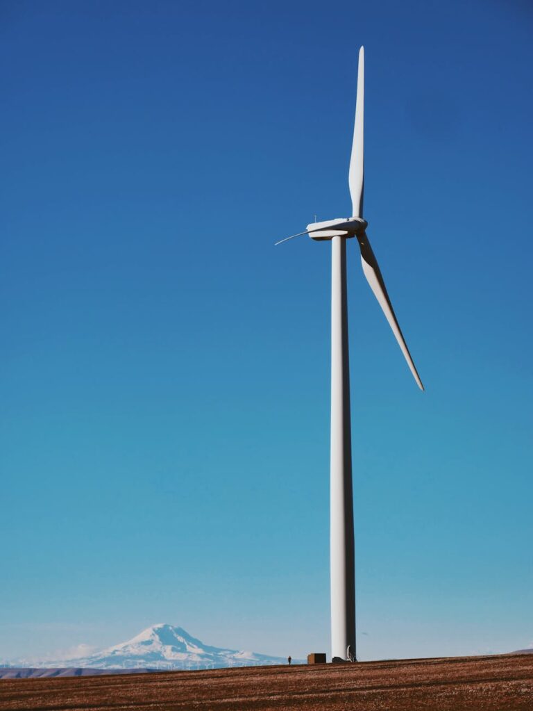 photo of wind turbine under blue sky