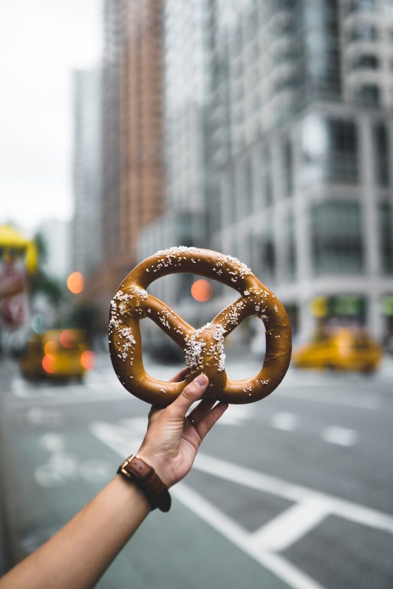 photo of person holding pretzels
