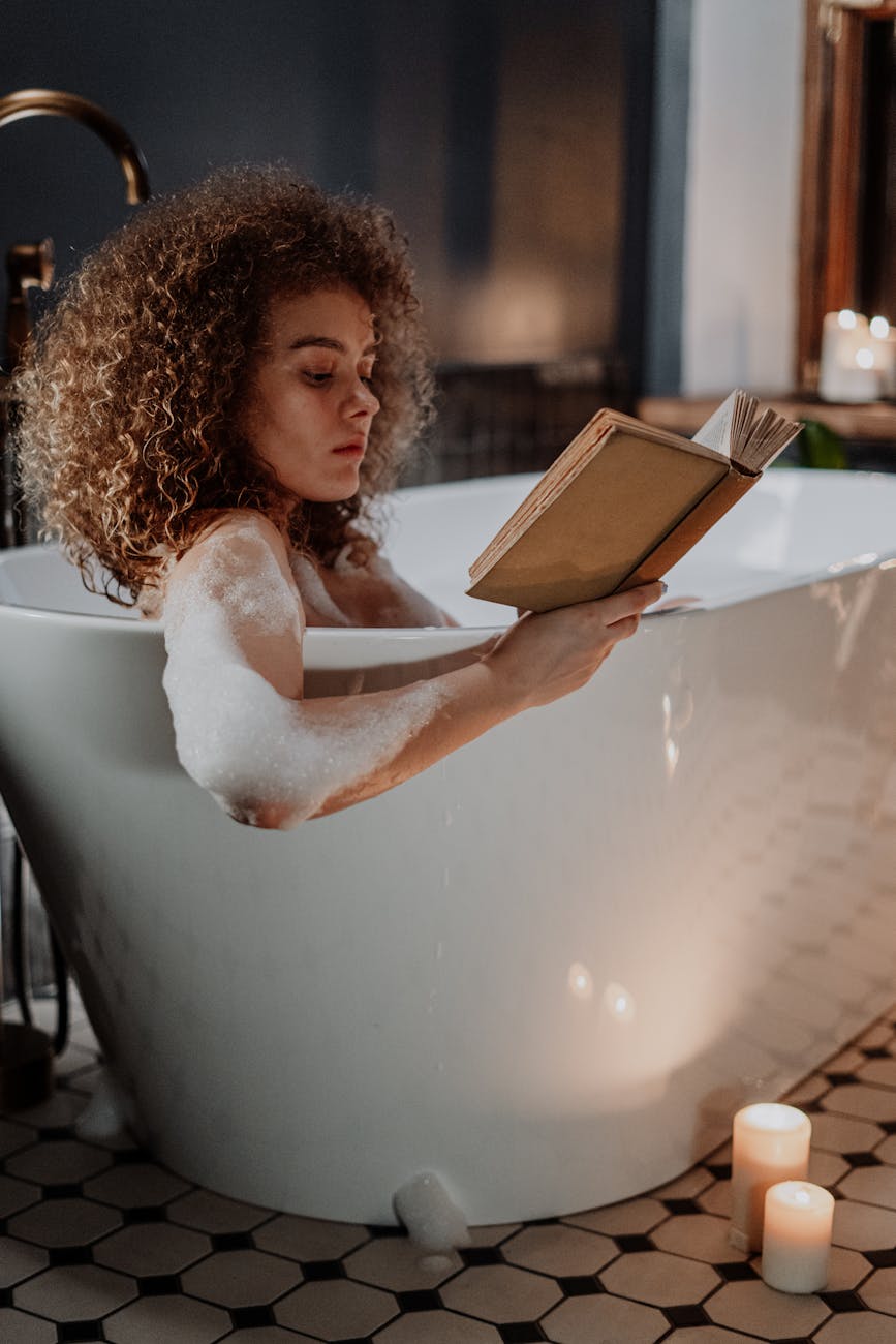 woman in white dress reading book