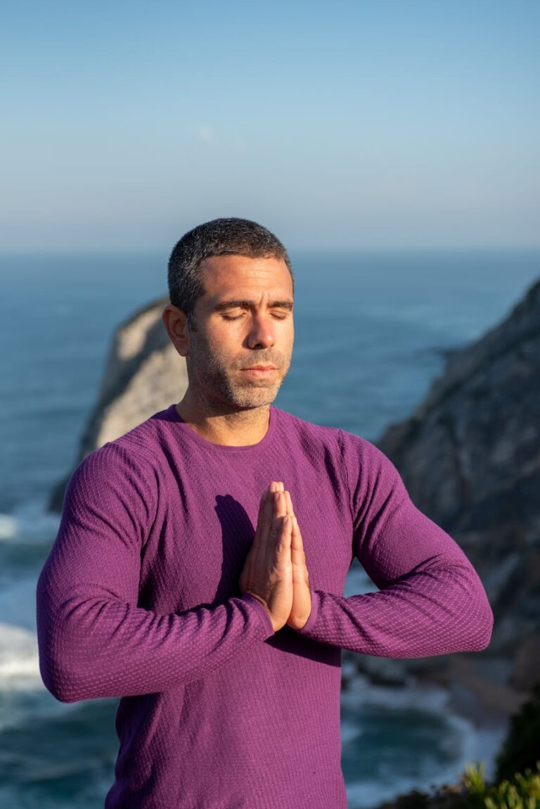 man in purple long sleeves meditating