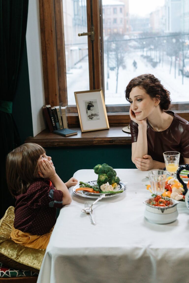 a mother and child leaning on the table