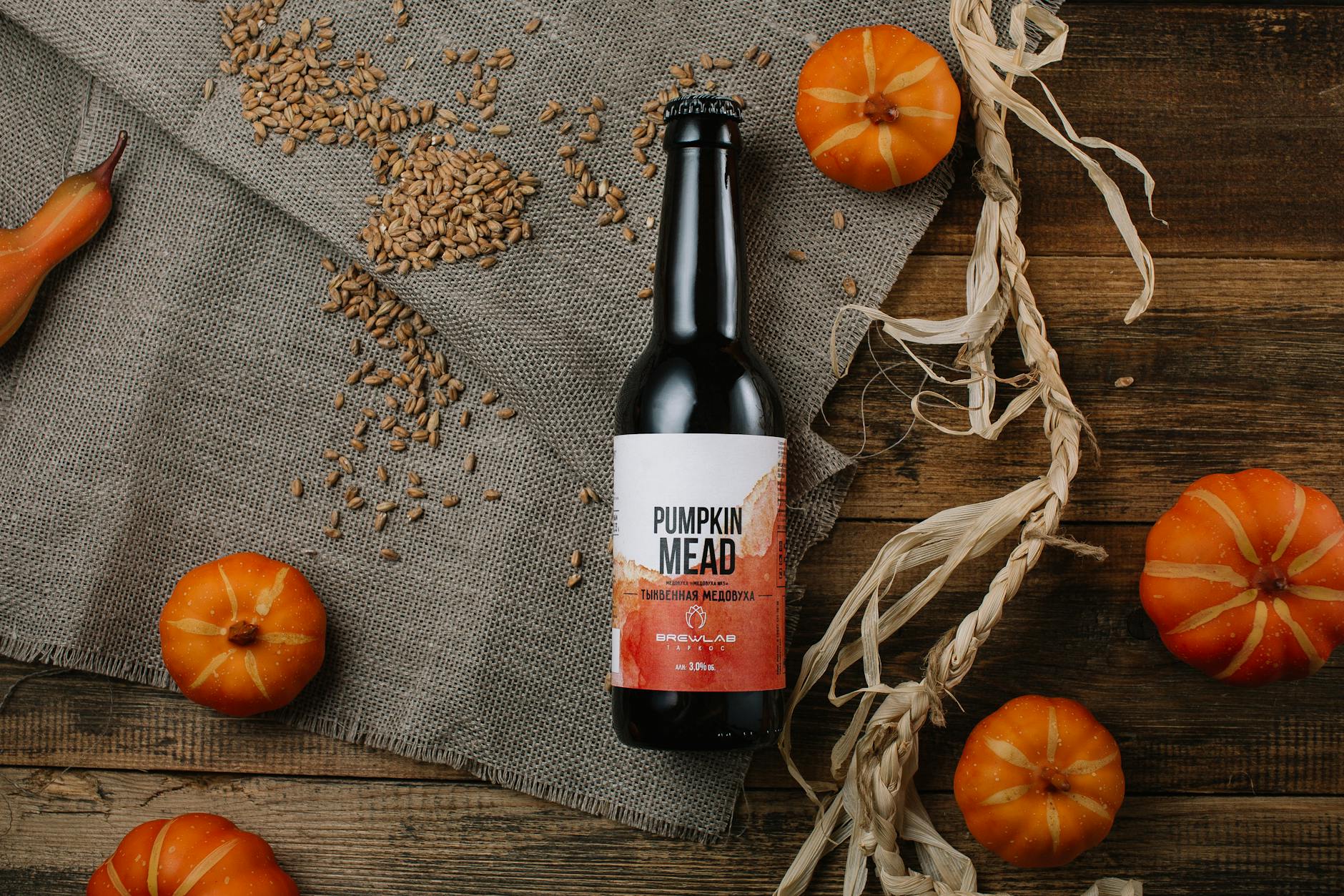 top view of pumpkins and a pumpkin bottled mead on a rustic table