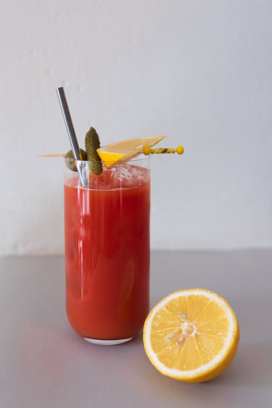 a bloody mary beside a sliced lemon