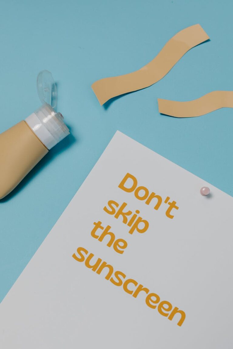 paper with a text saying dont skin the sunscreen lying on blue background