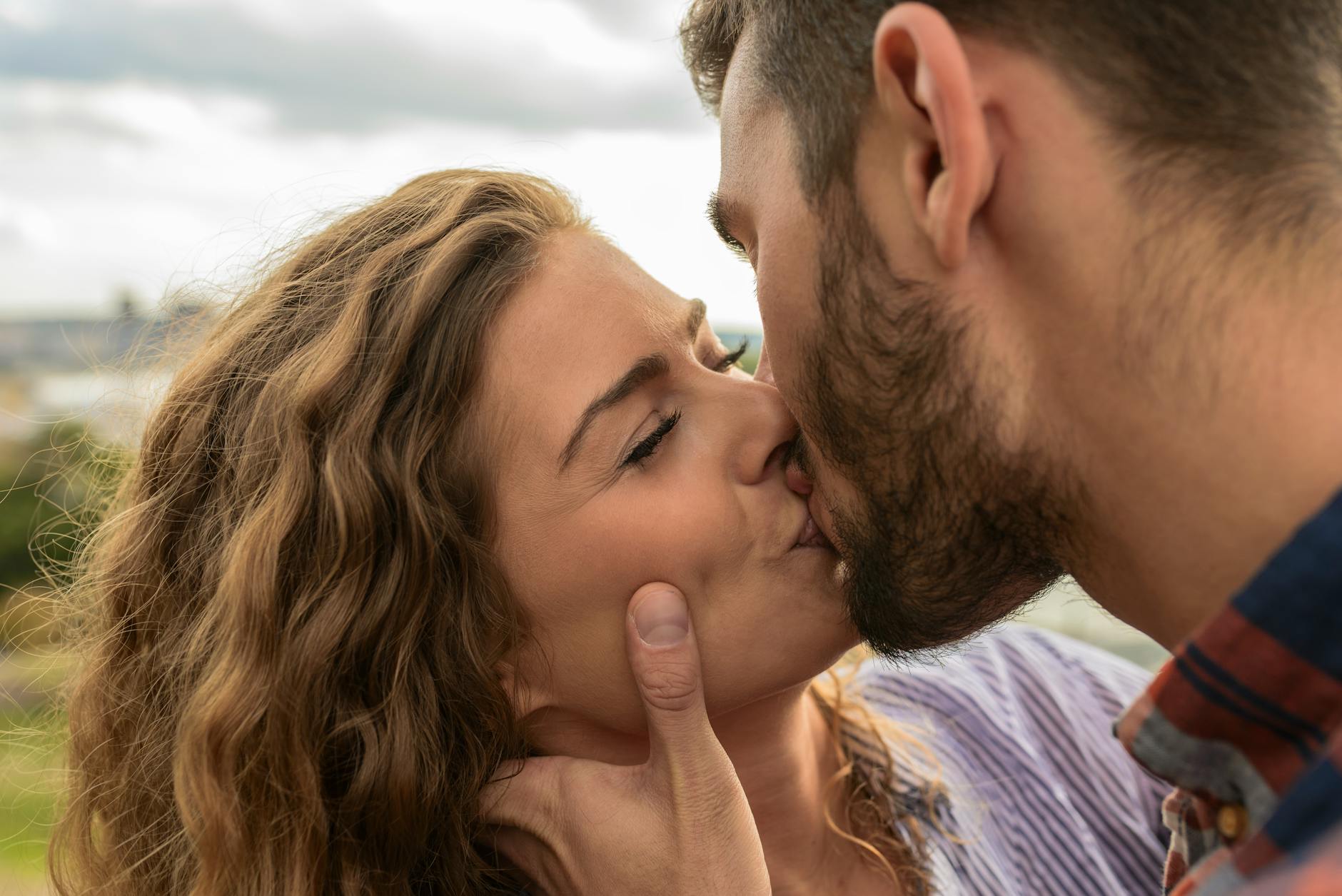 man and woman kiss each other
