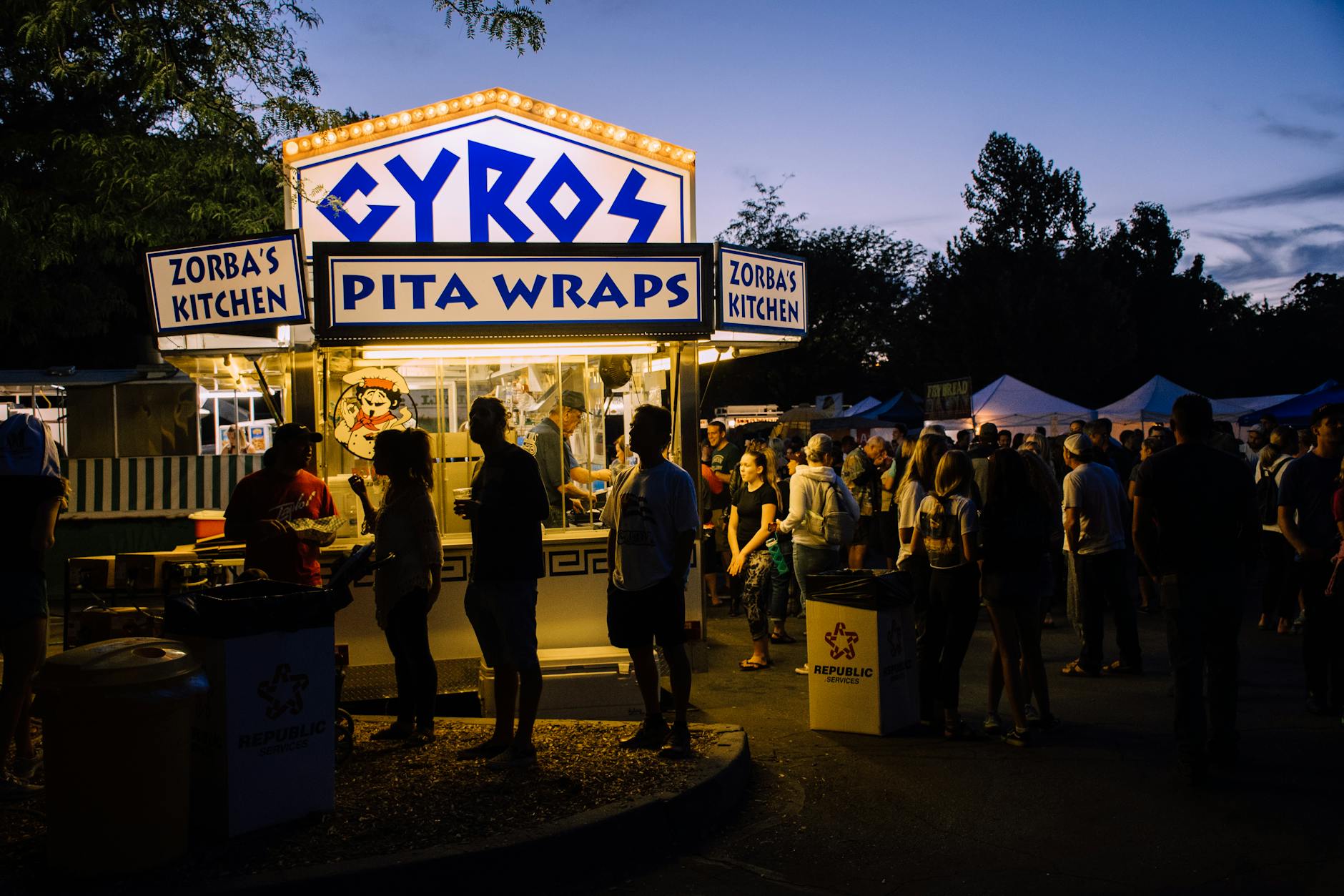 group of people near gyros pita wraps food stall