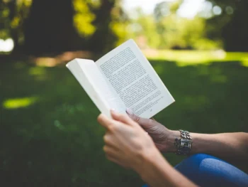 Free person reading book outside