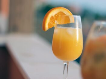 orange juice in clear drinking glass