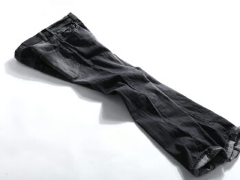 black denim jeans on white panel