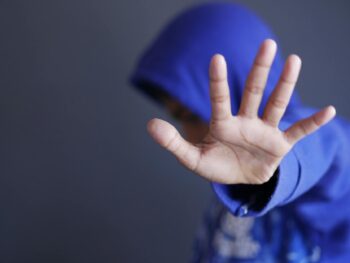 hand of person wearing blue hoodie