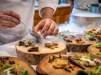 chef preparing vegetable dish on tree slab