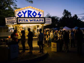 group of people near gyros pita wraps food stall