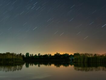 meteor shower above lake shore