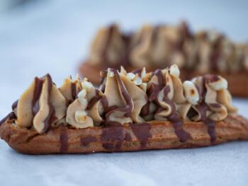 close up of an eclair with cream and chocolate