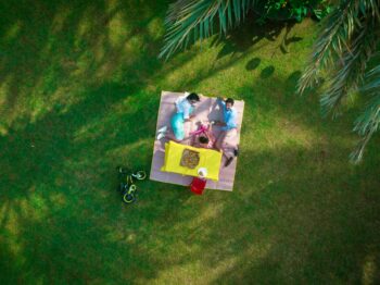 man and woman laying on picnic mat