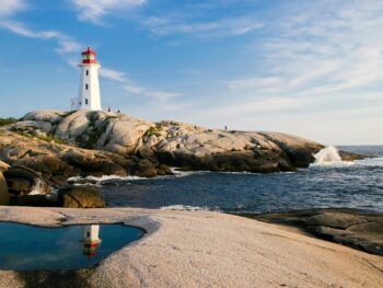 lighthouse by sea against sky