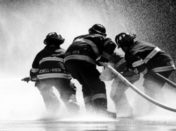 grayscale photo of firemen