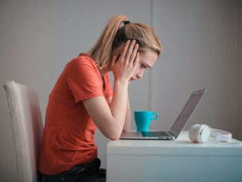 young troubled woman using laptop at home