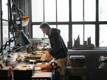 male master working with metal tools in garage