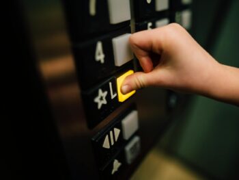 anonymous person pressing button of lift