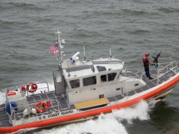 white orange u s coast guard boat on the sea