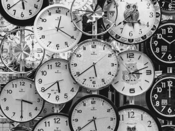 black and white photo of clocks