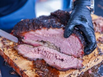 a person slicing barbecue beef brisket