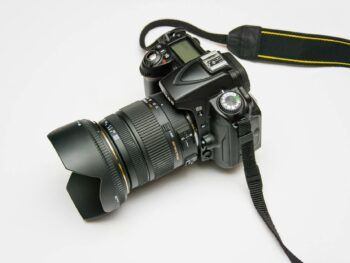 black dslr camera on white surface